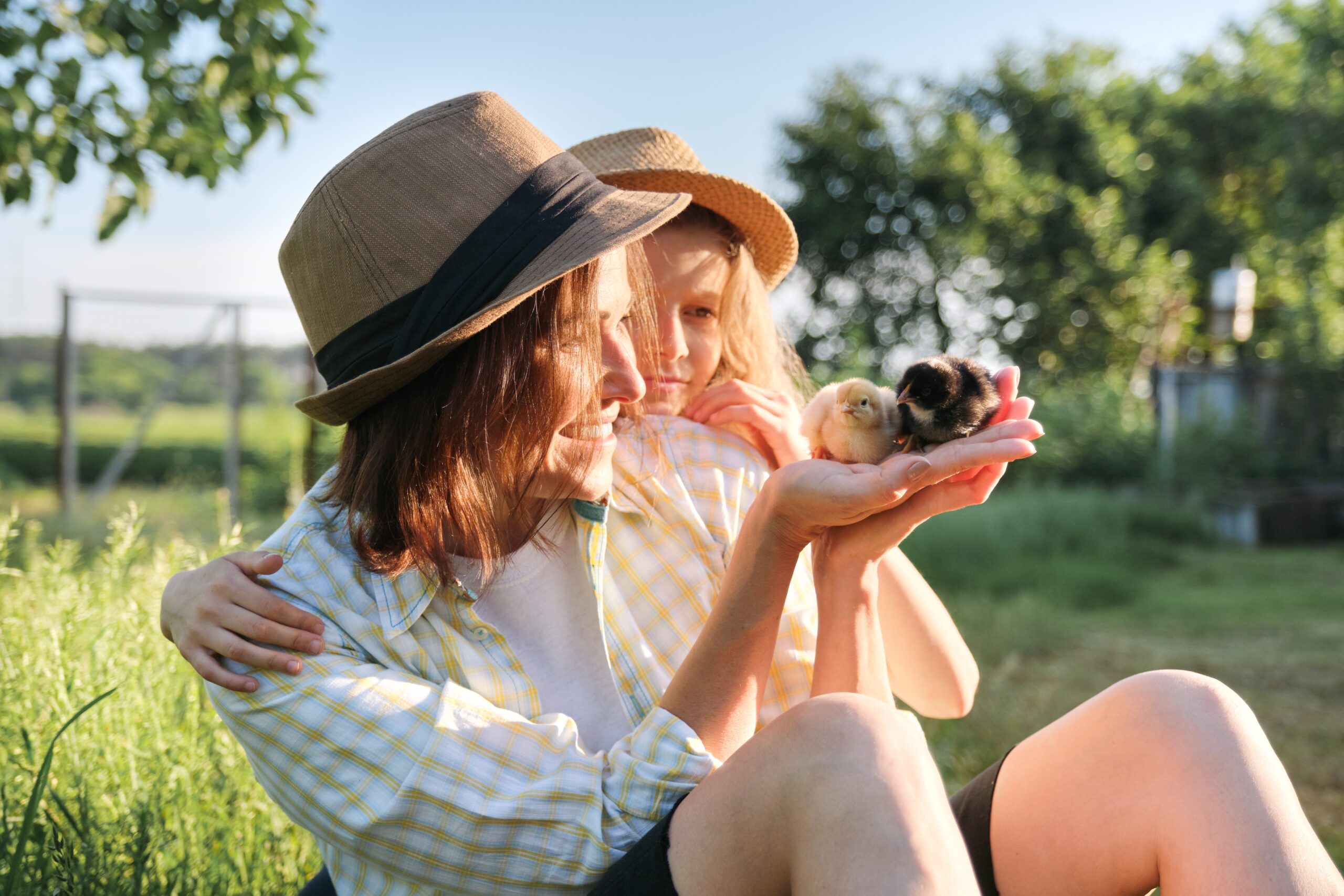 Mother and daughter hold baby chicks