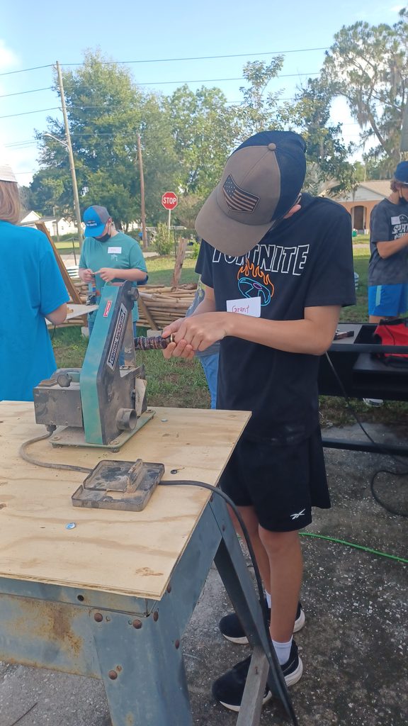 Teens learning bushcraft survival skills outdoors at Lakeland Highlands Scrub in Bartow, FL