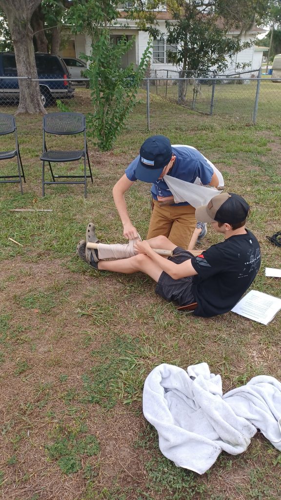 Teens learning bushcraft survival skills outdoors at Lakeland Highlands Scrub in Bartow, FL