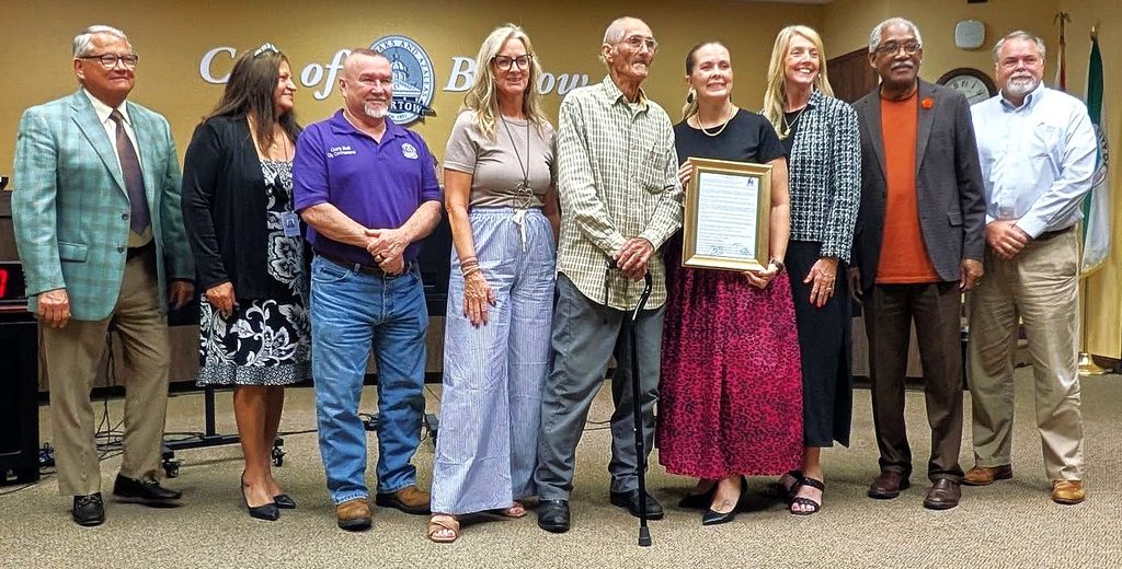 For half a century, Gerald Cochran has been an active participant at city commission meetings, as well as having been a candidate. Whether holding officials' feet to the fire or, upon occasion, complimenting them, he has demonstrated what it means to take an active role in the community. Standing with Cochran (center, holding onto a cane) are (from left:) City Manager Mike Herr, City Clerk Jacki Poole, Commissioners Gary Ball, Trish Pfeiffer, Mayor Tanya Tucker, Commissioners Laura Simpson, Leo Longworth, and City Attorney Sean Parker