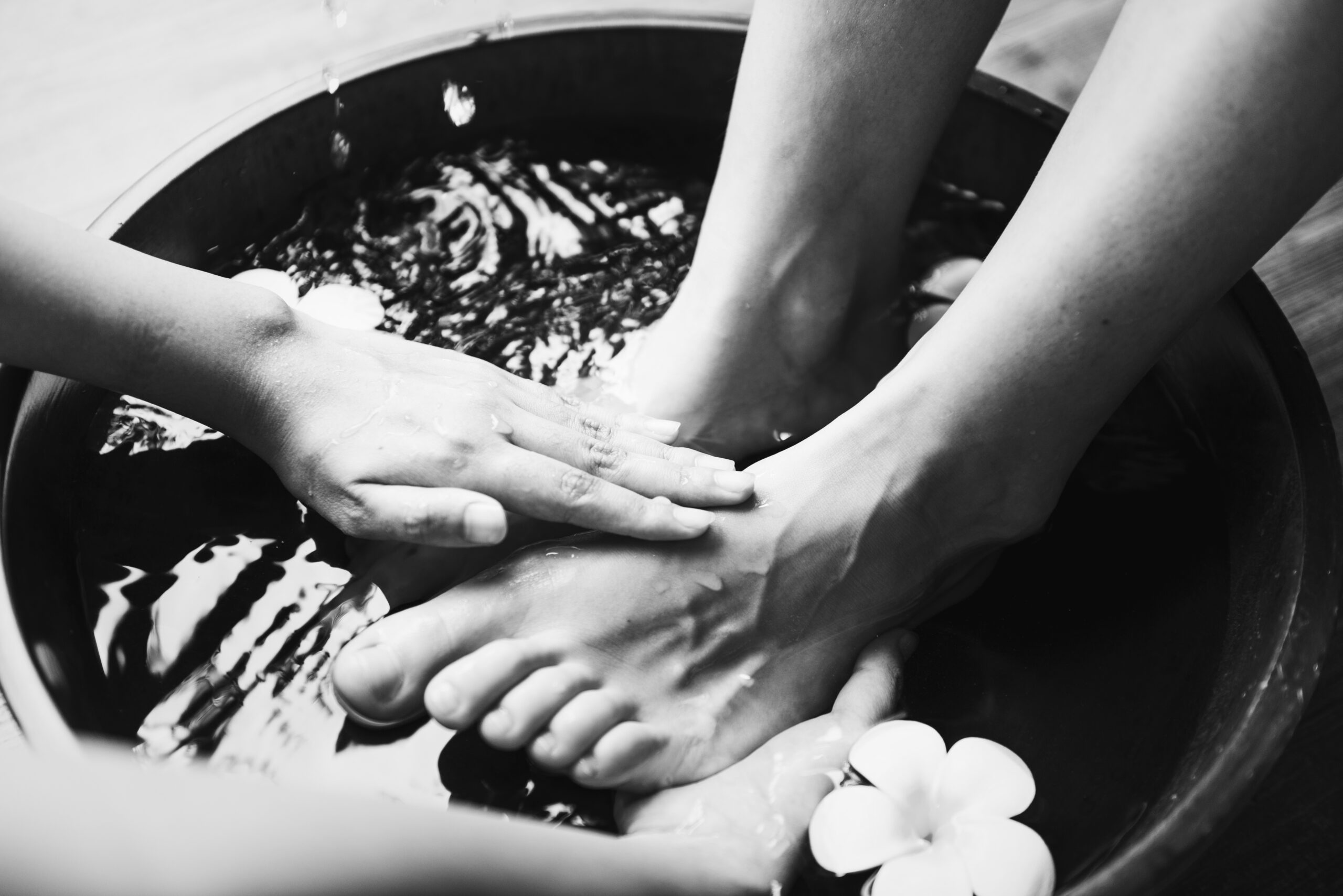 Hands gently washing feet, symbolizing humility and service in the towel and basin devotional