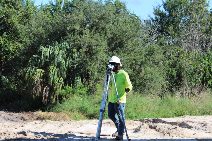 A surveyor works at the water plant site.