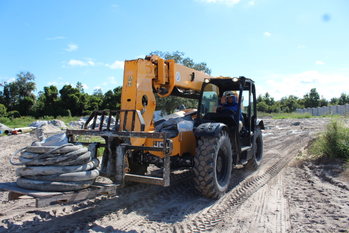Workers move materials across the 3.69 square acres site.