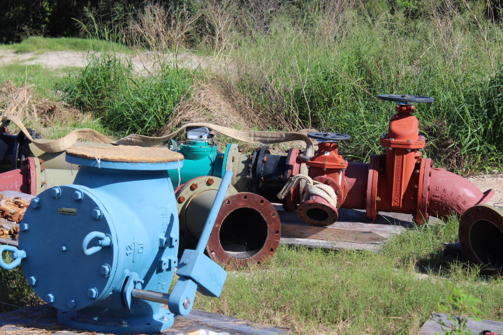Valves, pipes, and connections ready to be installed near the main pump at the deep well.