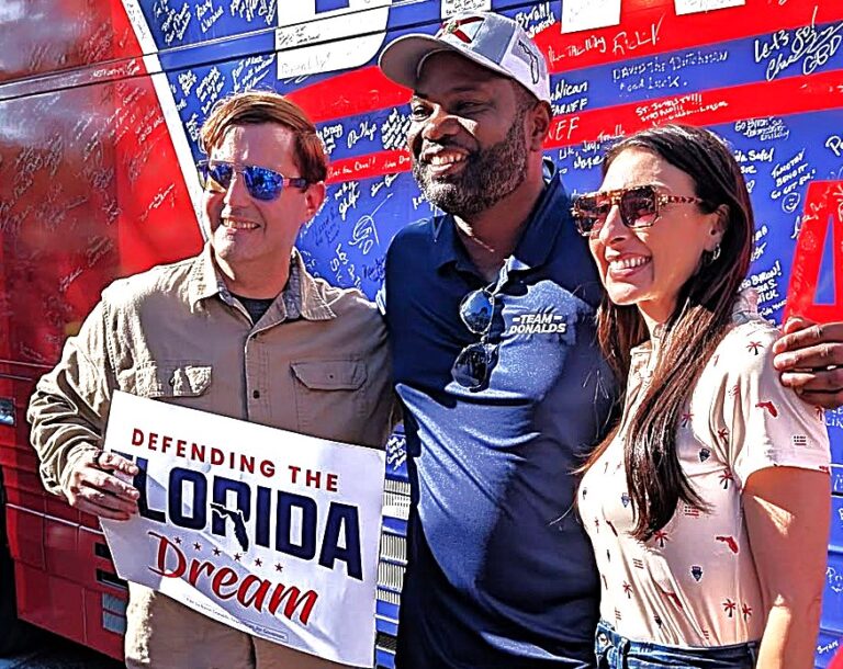 Republican gubernatorial nominee Byron Donalds and his wife, Erika Donalds, pose with a supporter at the Polk County