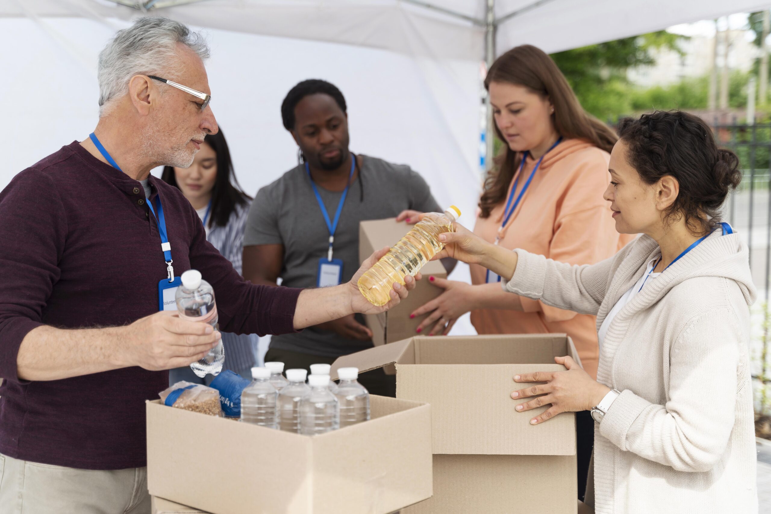 Hands sharing gifts with others, symbolizing stewardship through community service