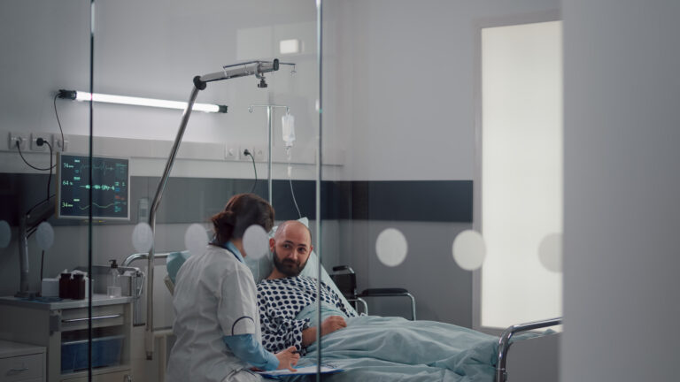 A calm sunrise through a hospital room window, symbolizing peace and surrender before surgery