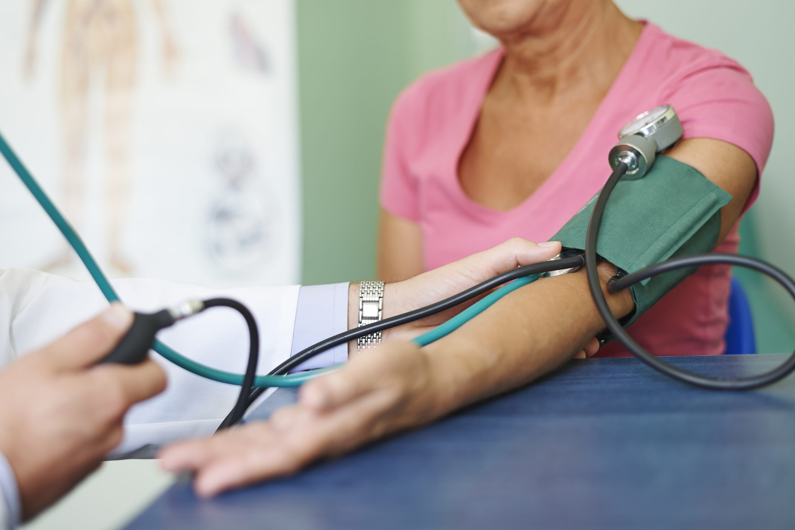 A health care worker checks a Polk County resident's blood pressure at a free community health screening.