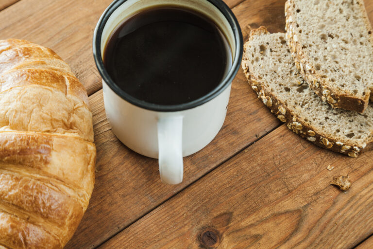 bread and cup on wooden table