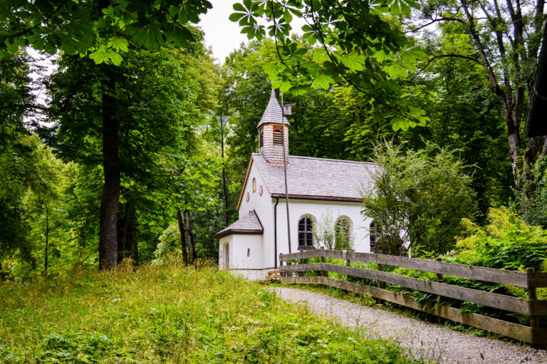 Small country church with a white steeple under a blue sky